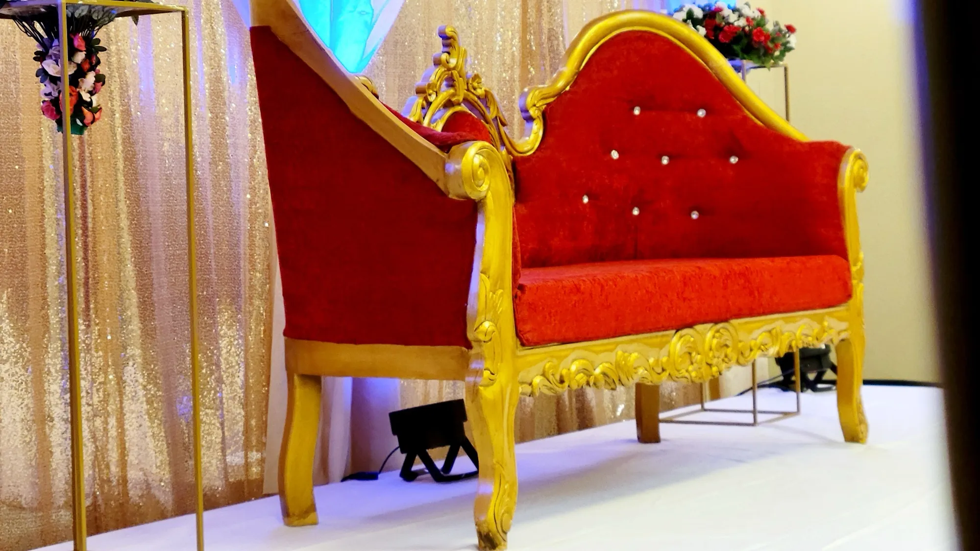 Red gold loveseat closeup — Sequin Drapes & Red Loveseat Reception