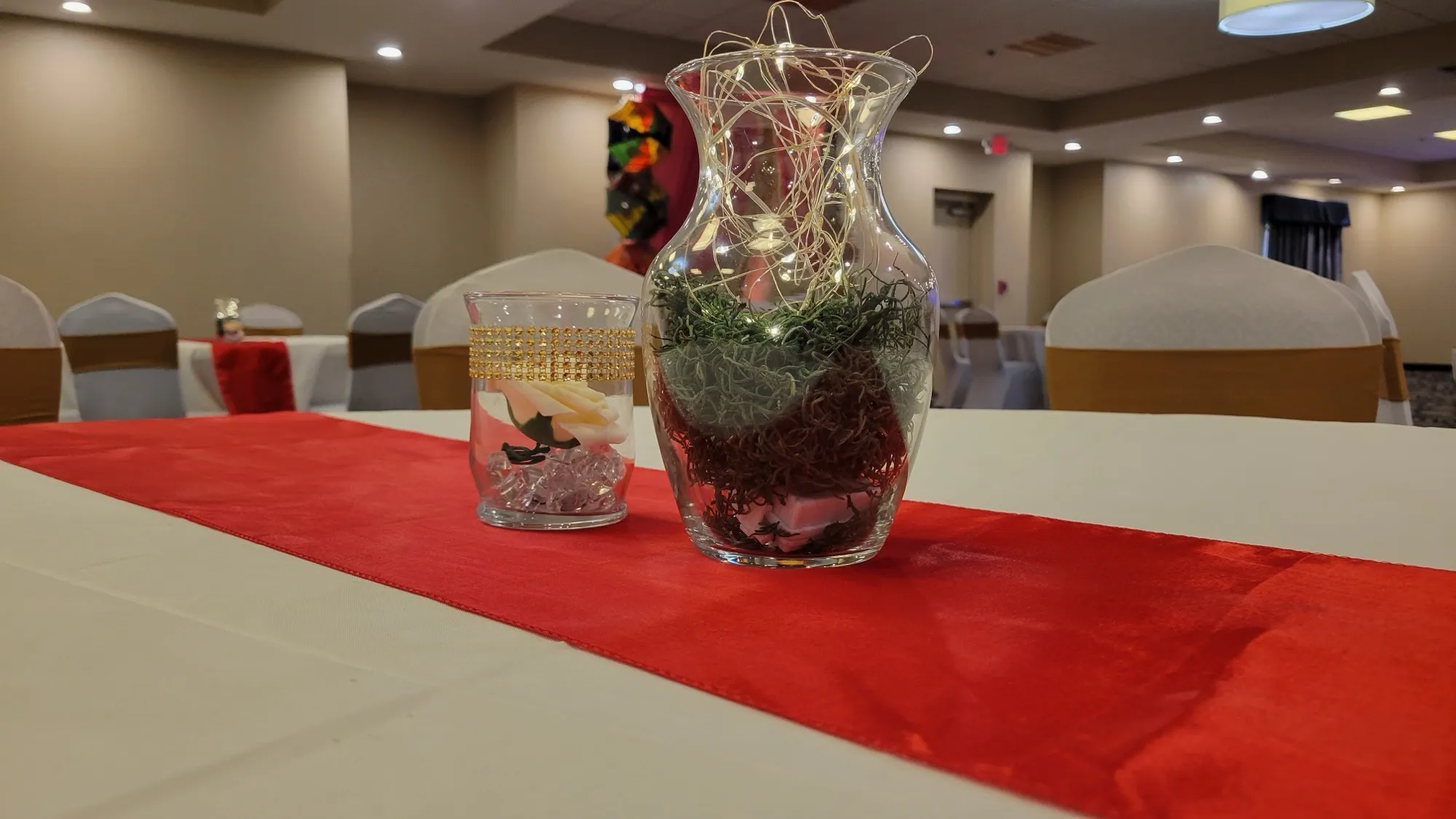 Table centerpiece vase fairylights — Sequin Drapes & Red Loveseat Reception