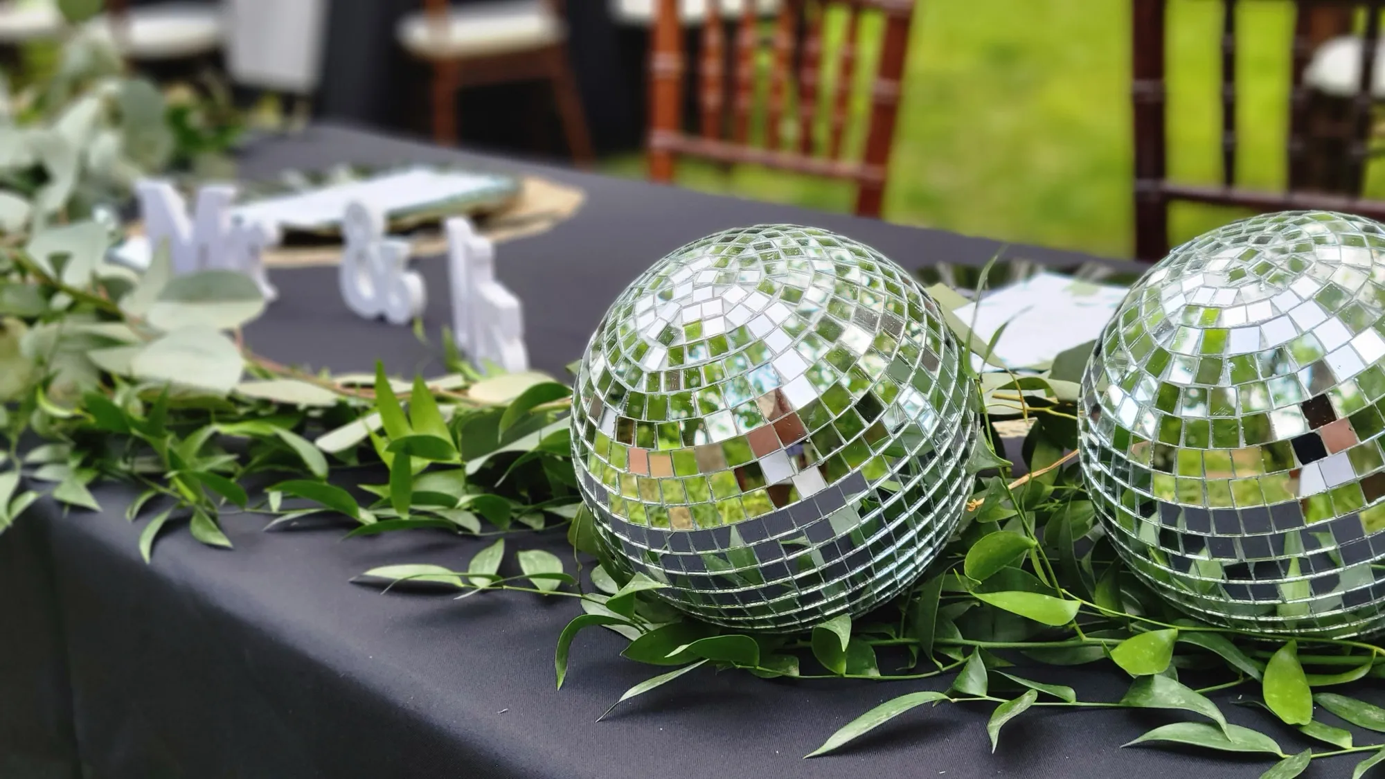 Sweetheart table disco balls greenery — Rustic Bamboo Garden Mandap