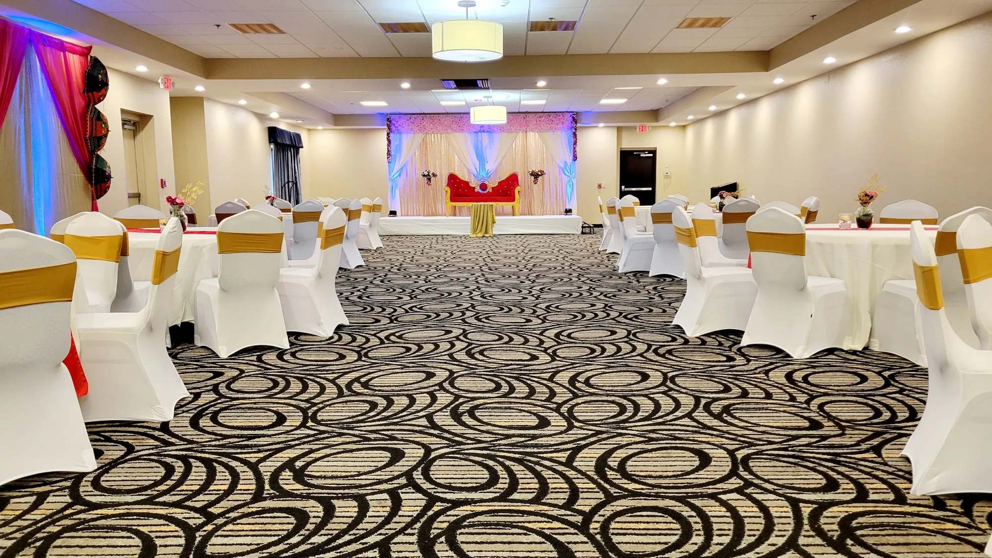 Reception hall table setup — Sequin Drapes & Red Loveseat Reception