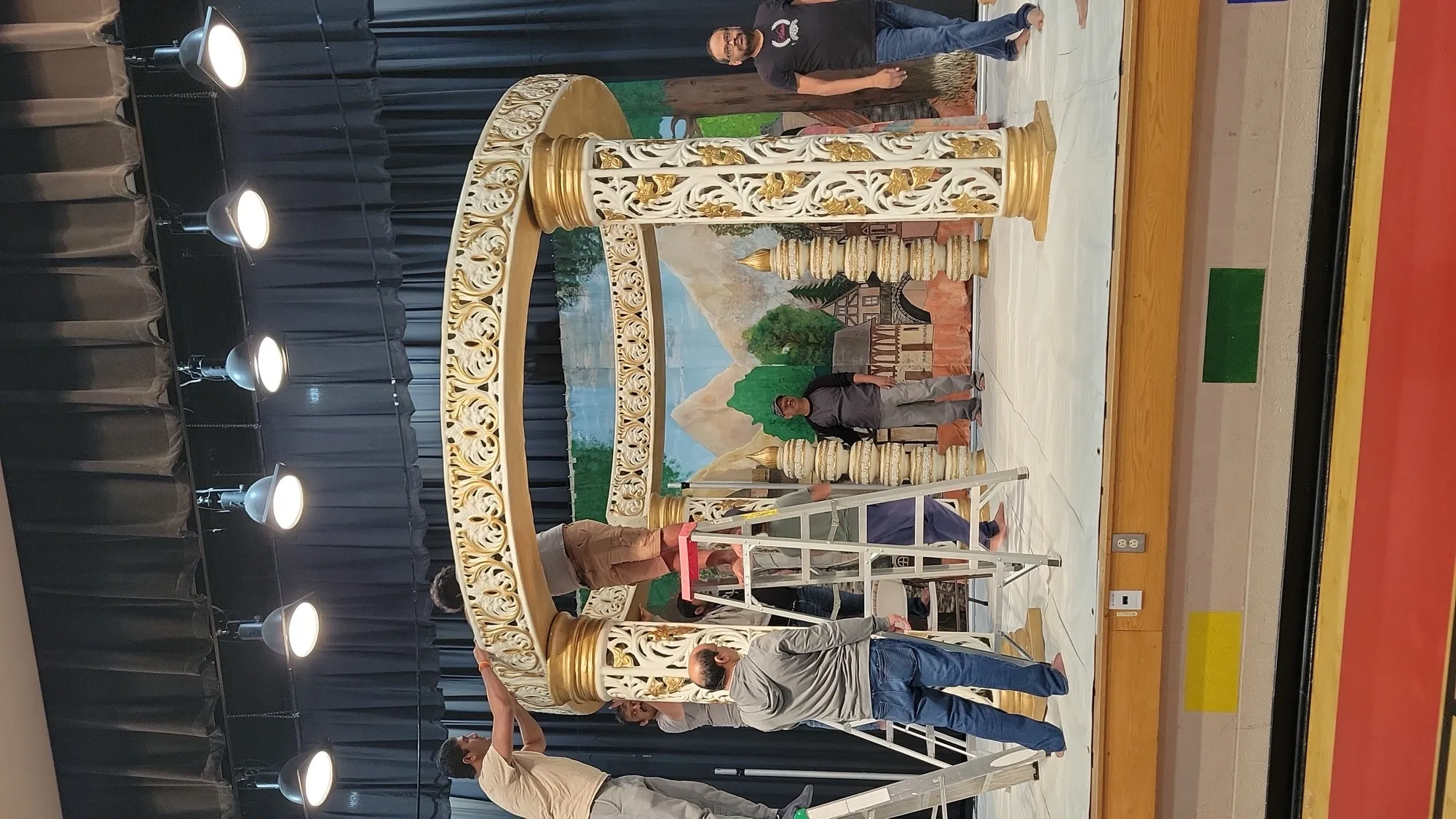 Setup in progress team building — Yellow & Gold Mandap with Paisley Pillars